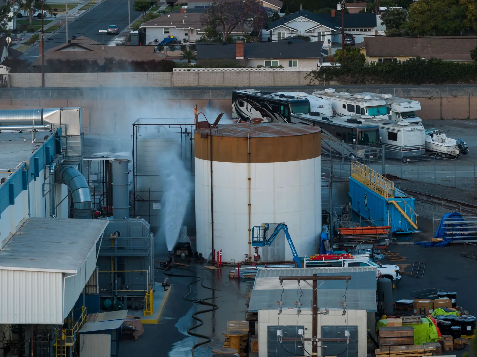 Water is sprayed on a tank that overheated at an aerospace plant in Garden Grove, California, on May 22. (AP Photo/Ethan Swope)