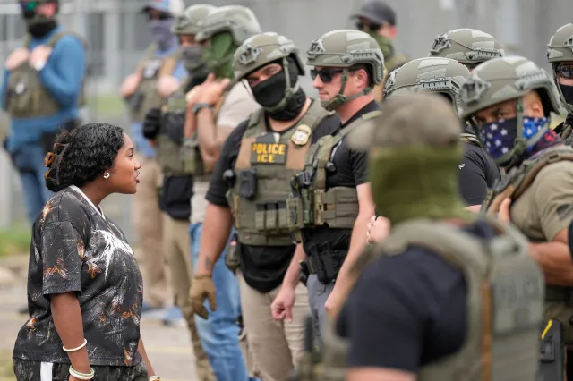 A protester addresses masked federal agents outside the Delaney Hall detention center during a protest against the transfer of detainees on May 27, 2026, in Newark, New Jersey.