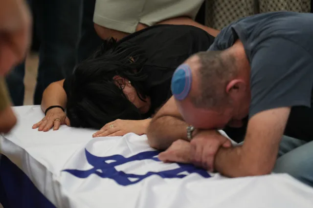 Hilit Yanai, left, mourns over the coffin of her daughter, Israeli soldier Sergeant Rotem Yanai, who was killed in a Lebanese drone attack in northern Israel, during her funeral in Givat Ada, Israel, on May 28, 2026.