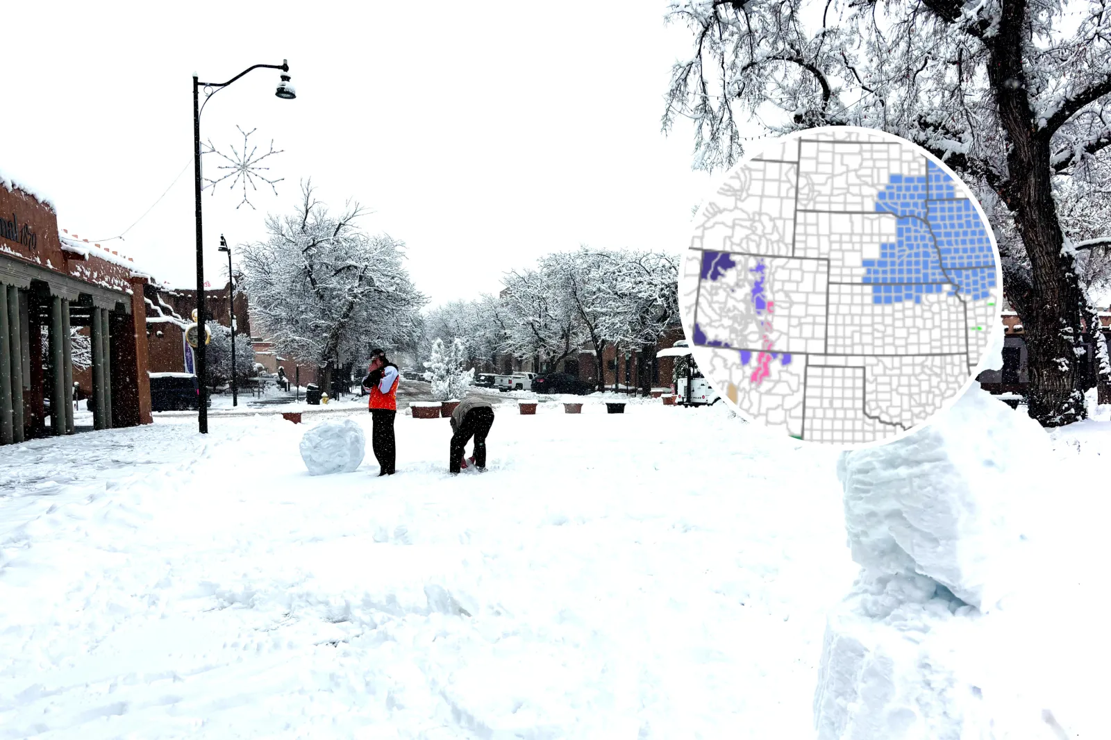 Stock image: Santa Fe, NM: Two young men making snowmen on the historic Santa Fe Plaza after a snowstorm - undated