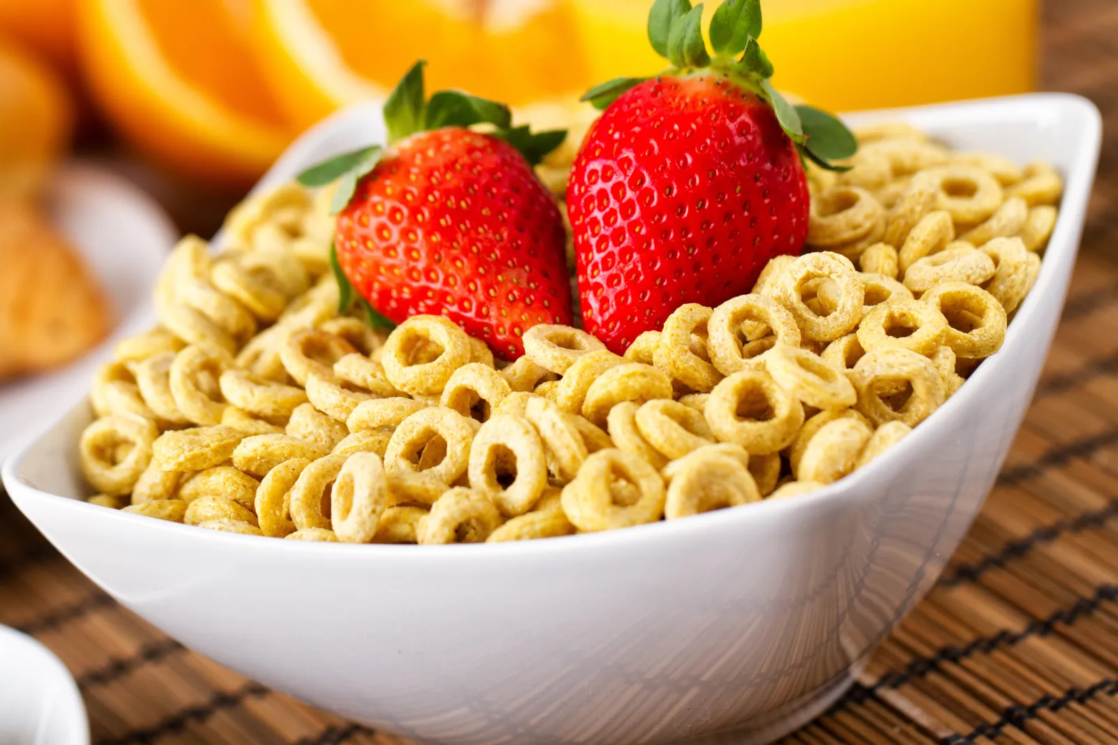 Stick image of a bowl of cereal with milk and strawberries.