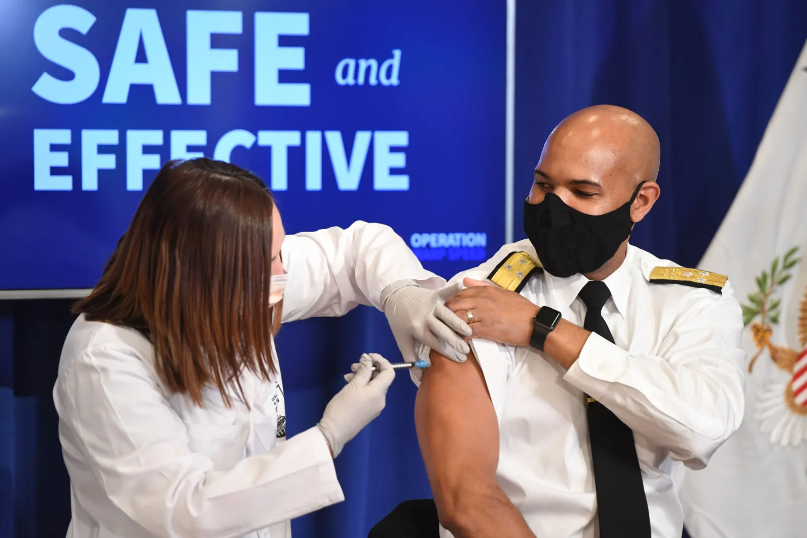 US Surgeon General Jerome Adams receives the COVID-19 vaccine in the Eisenhower Executive Office Building in Washington, DC, December 18, 2020.