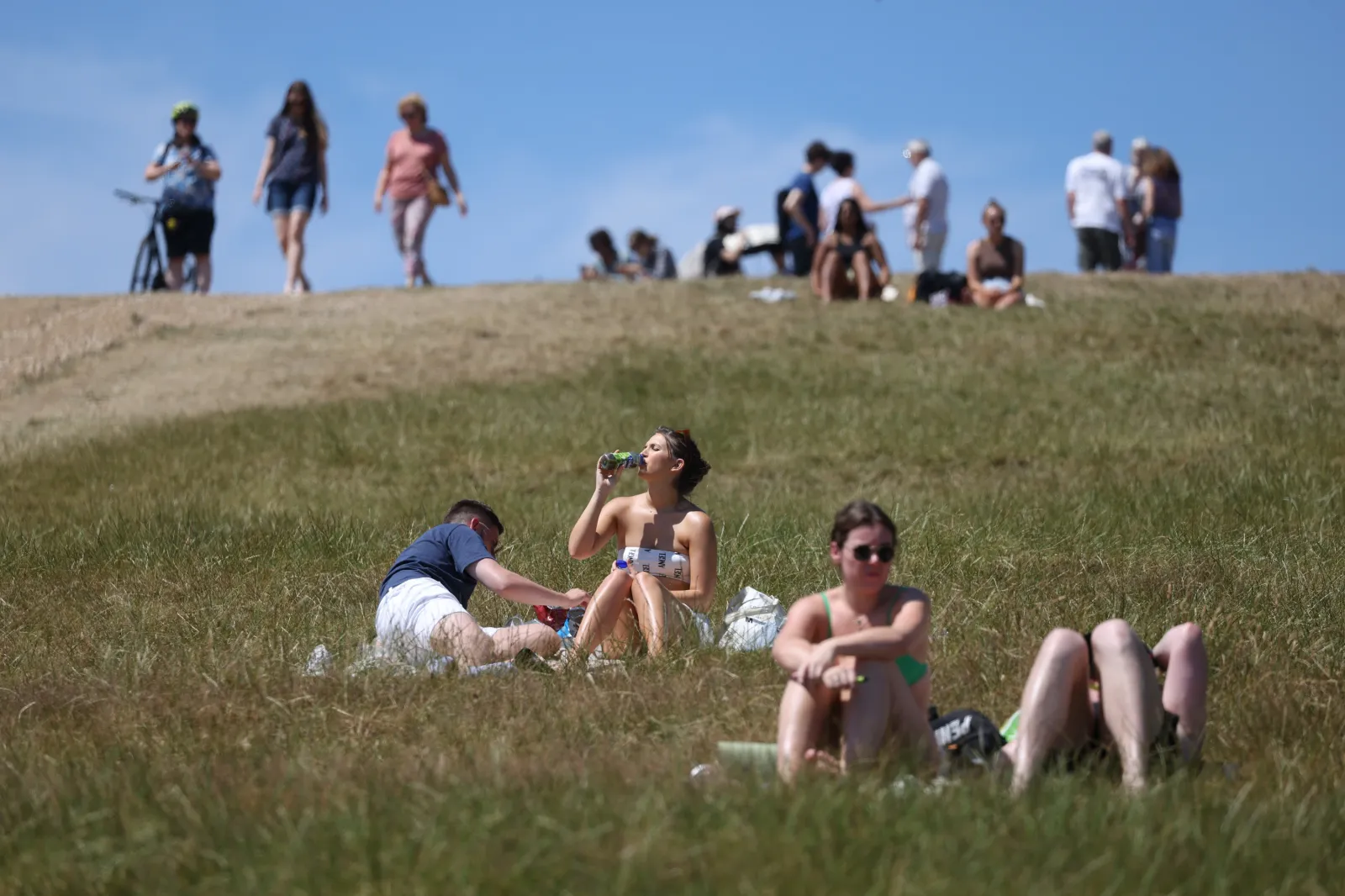 People sunbathe on Primrose Hill in July 2022 in London, England.