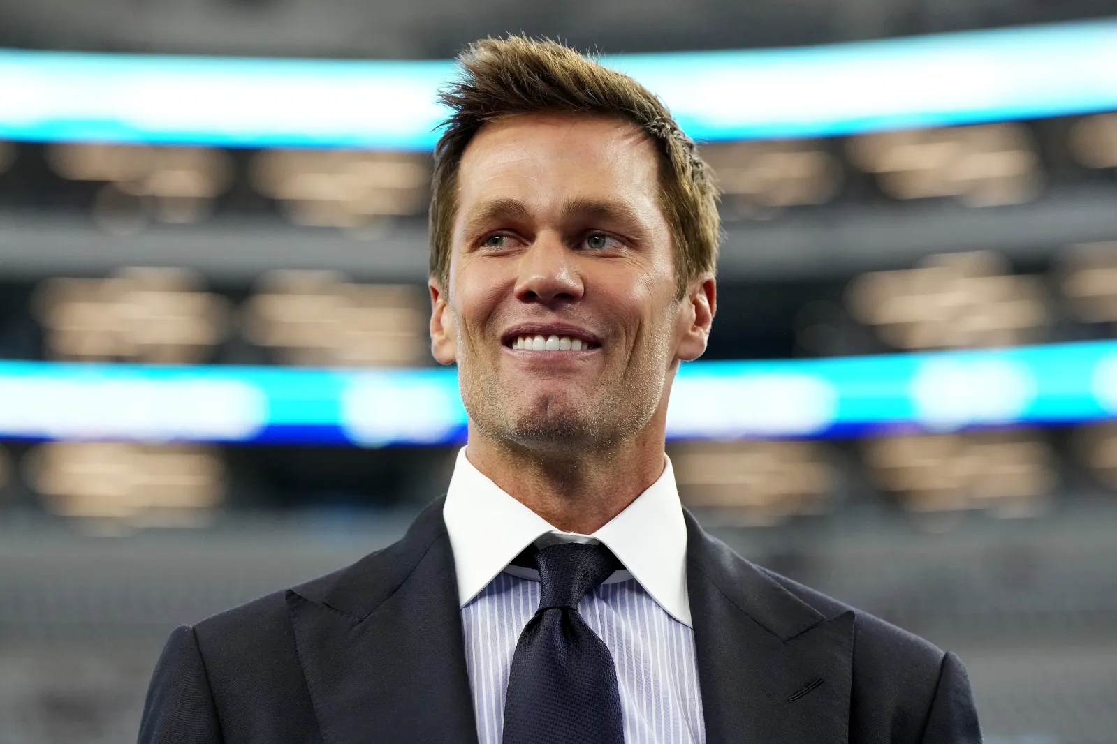 Tom Brady looks on.