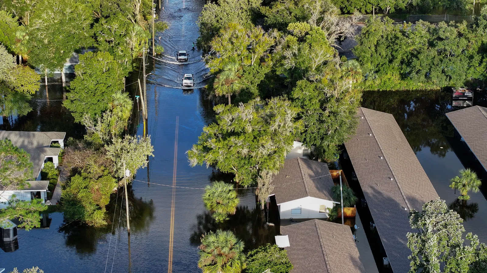 Vehicles drive through flood waters in Crystal River, Florida after Hurricane Helene hit the area in September 2024.