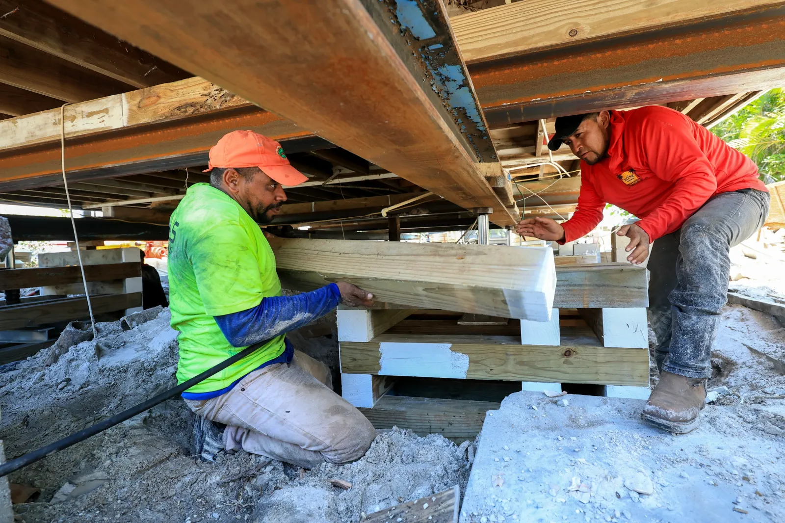 Construction workers at a home elevation project site on Treasure Island in Florida.