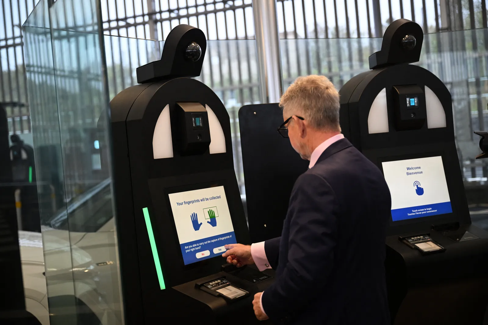 A person uses an automated Entry/Exit System (EES) kiosk during a preview of the rollout in England in September 2025.