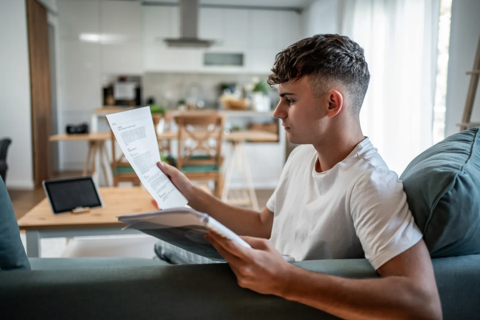 Stock image/file photo: Young man looking at documents.