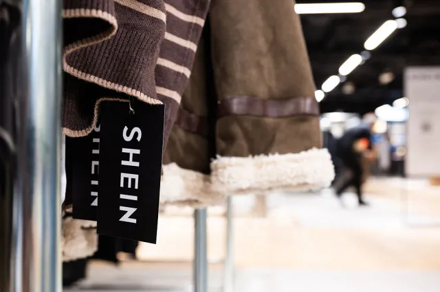 A closeup of a Shein clothes tag at the Bazar de l'Hotel de Ville (BHV) department store in Paris.