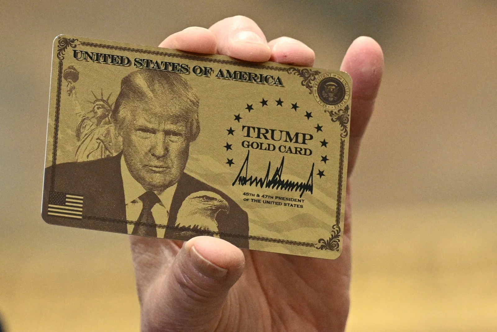 President Donald Trump holds up a 