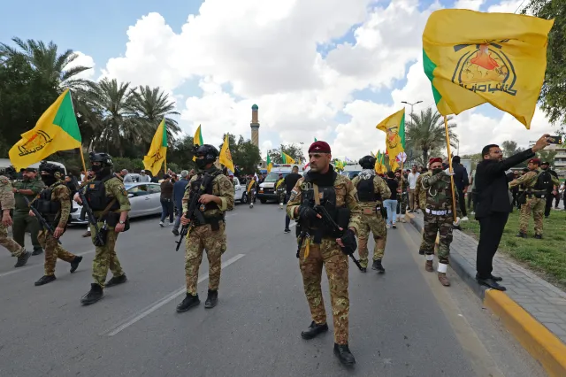 Members of Iraq's pro-Iran paramilitary group Hezbollah Brigades (Kataeb Hezbollah) gather in a mourning procession for one of their comrades who was killed the previous day in a strike in Basra, during the funeral in Baghdad on April 8.
