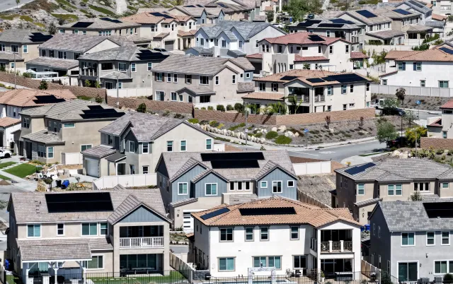 An aerial view shows homes with solar panels in a housing development on April 7, 2026 in Santa Clarita, California.