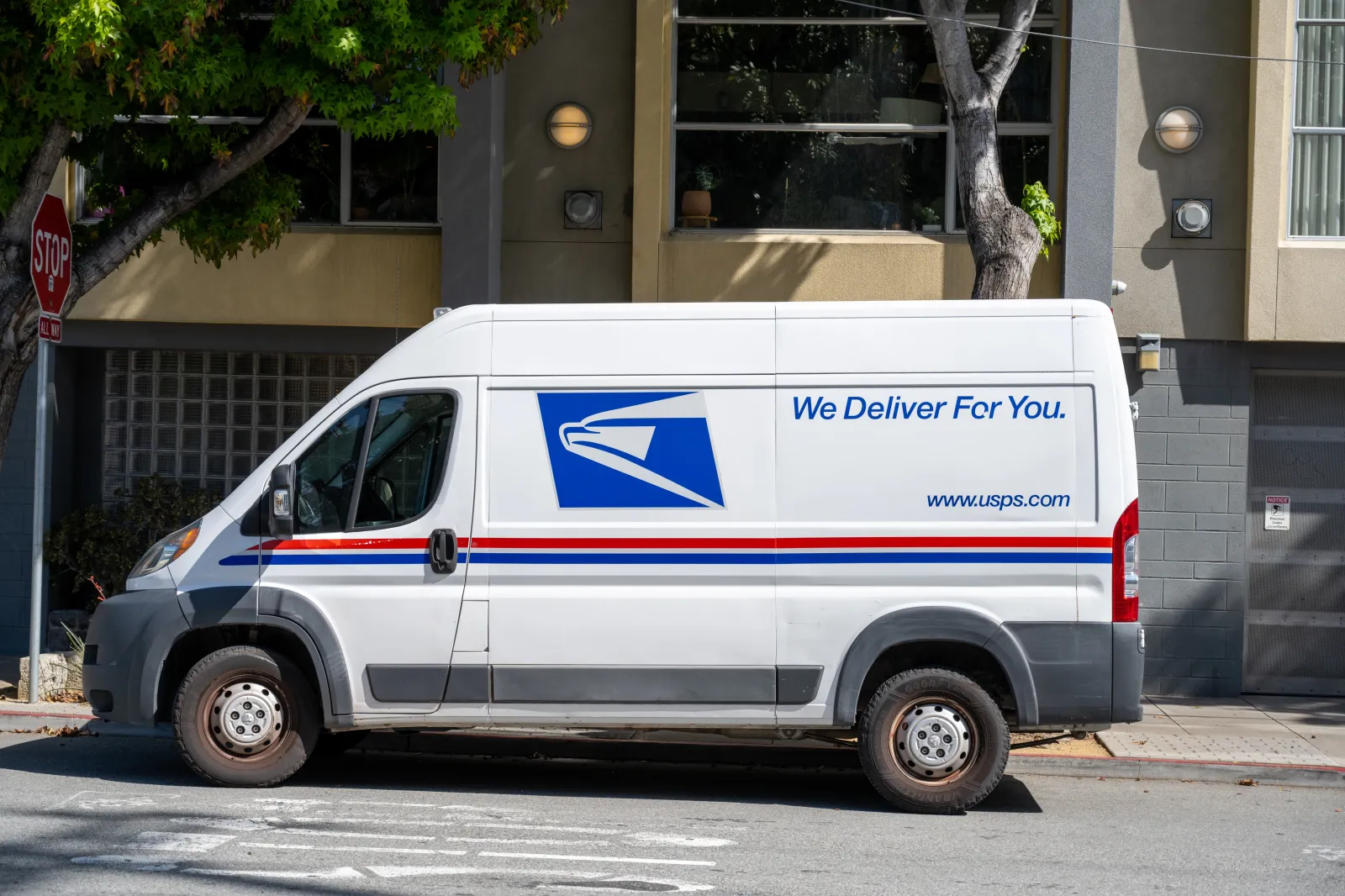 United States Postal Service delivery van parked on residential street in front of a building, San Francisco, California, April 28, 2026.