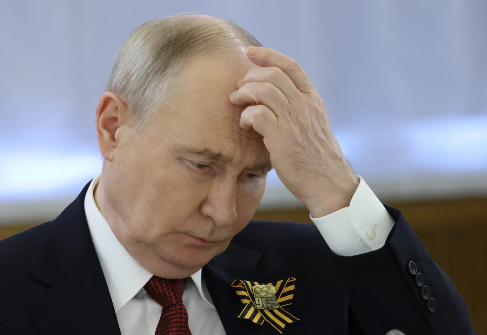 Russian President Vladimir Putin grimaces after the Victory Day parade, on May 9, 2026, in Moscow.