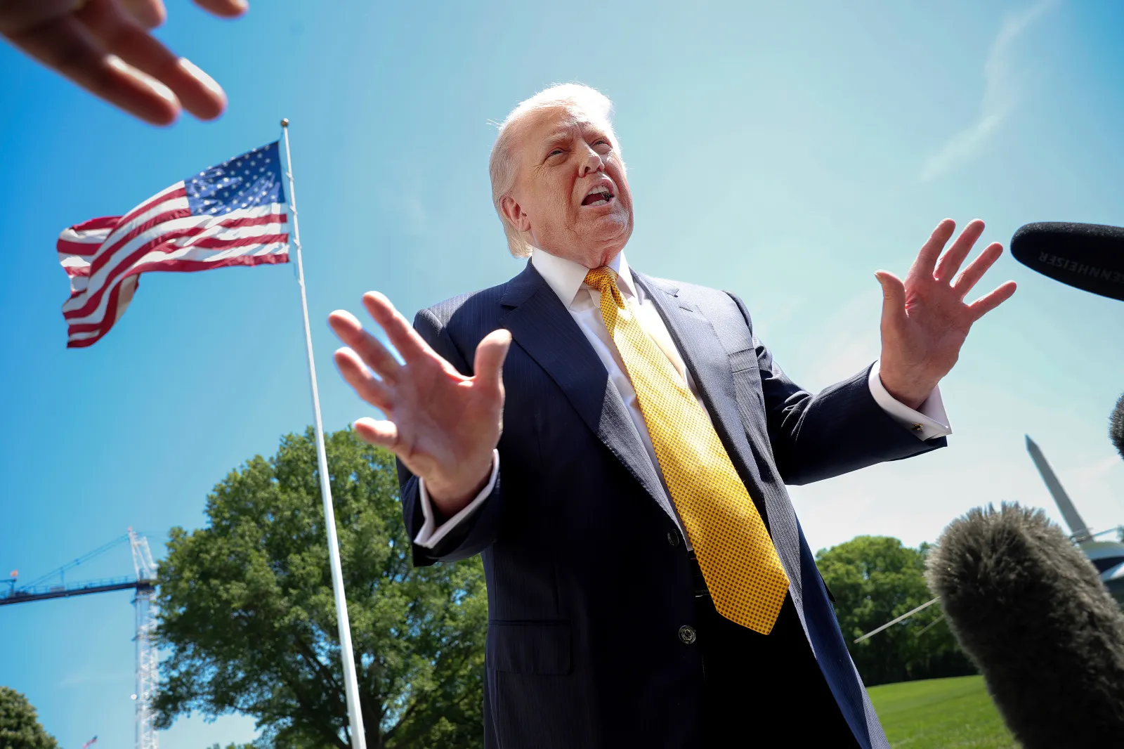 President Donald Trump speaks in front of the American flag to the press as he departs the White House on May 12, 2026, in Washington, D.C. (Photo by Kevin Dietsch/Getty Images)