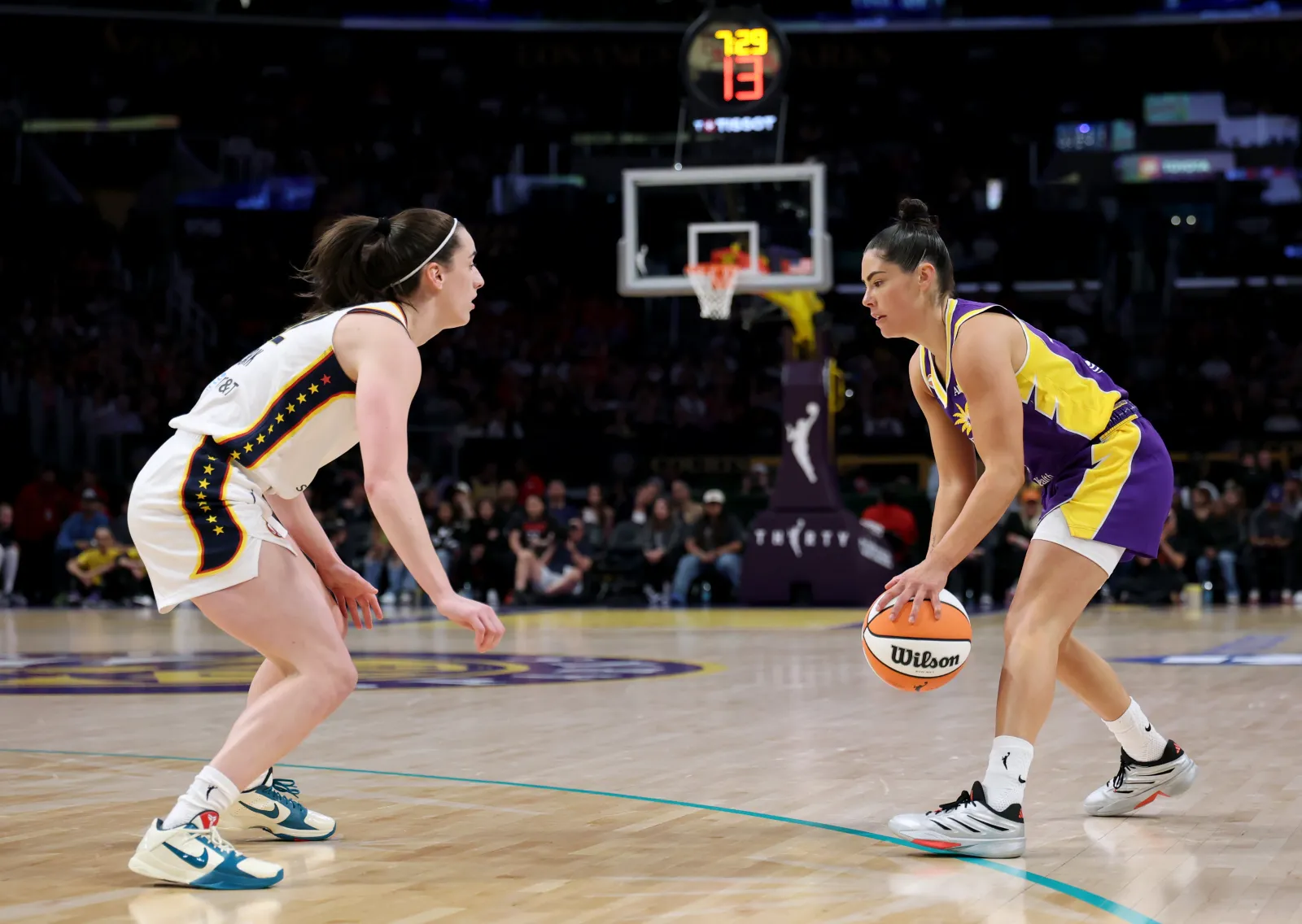 LOS ANGELES, CALIFORNIA - MAY 13: Kelsey Plum #10 of the Los Angeles Sparks dribbles in front of Caitlin Clark #22 of the Indiana Fever at Crypto.com Arena on May 13, 2026 in Los Angeles, California. (Photo by Harry How/Getty Images)