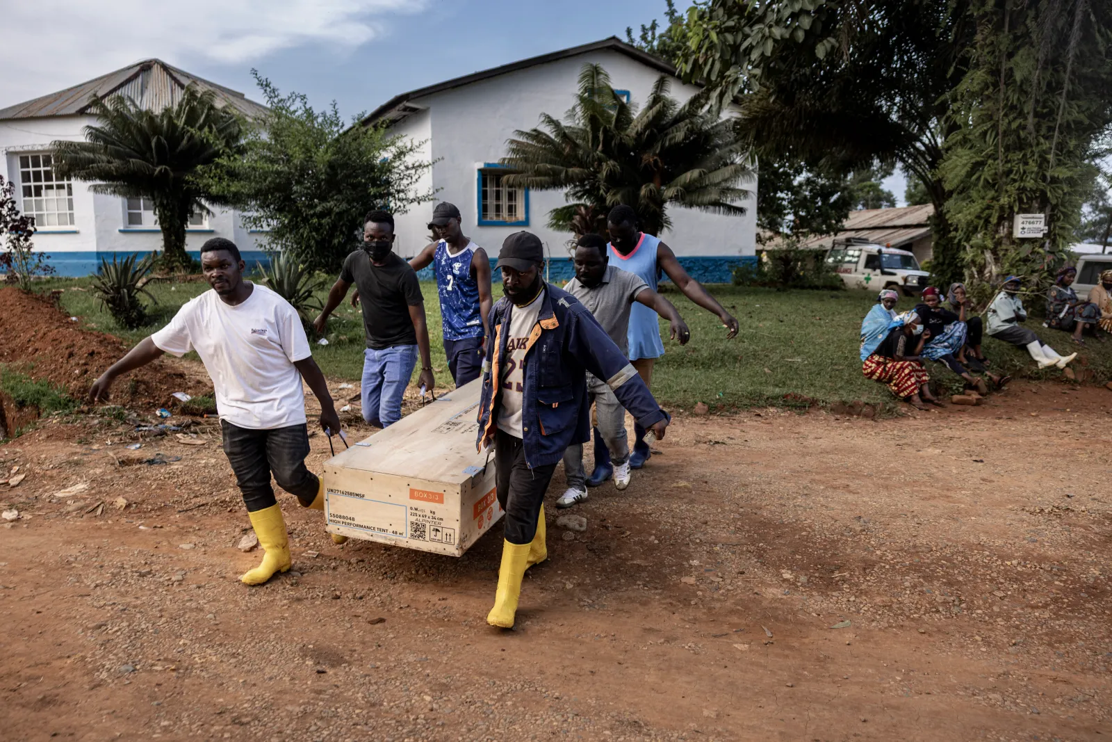 Workers carry equipment as they erect a temporary emergency tent near the General Referral Hospital of Mongbwalu during the Ebola outbreak response in Mongbwalu, Ituri province, eastern Democratic Republic of Congo, on May 20. (Photo by Michel Lunanga/Getty Images)