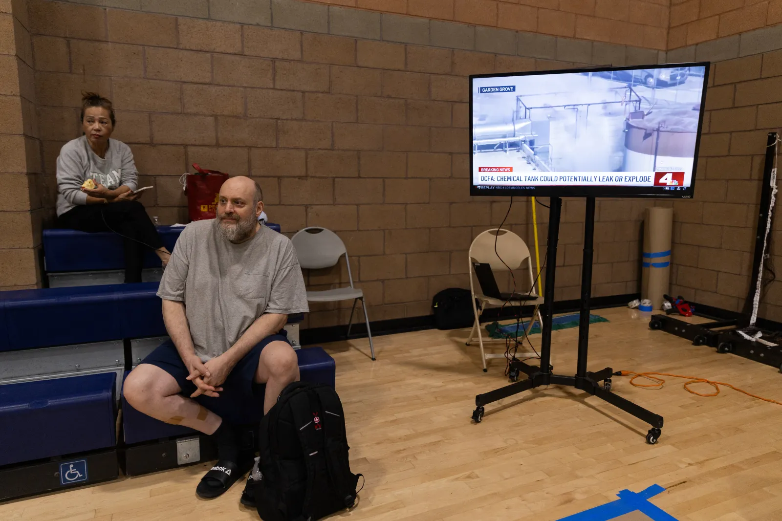 Evacuees in a shelter while the news plays on a television after a chemical leak from a large storage tank threatened residents in Garden Grove, California, on May 22, 2026.