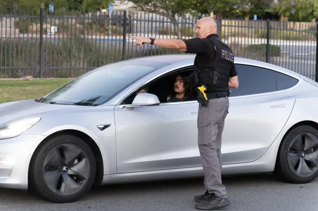Police direct evacuees toward a shelter in Garden Grove, California, on May 22, 2026.