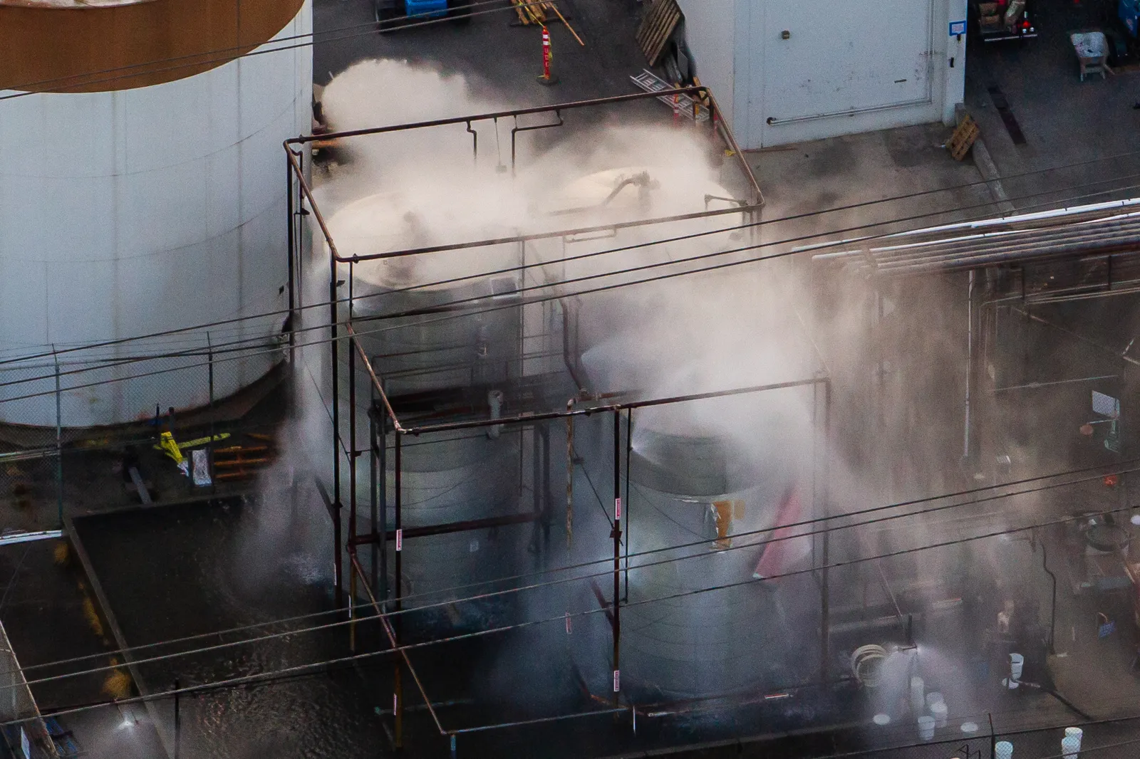 An aerial view of water being sprayed onto an overheated 34,000-gallon tank at GKN Aerospace on May 23, 2026 in Garden Grove, California.