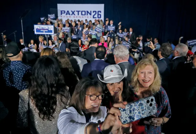 Supporters of Texas Attorney General Ken Paxton take a selfie at a primary election watch party in Plano on May 26, 2026.