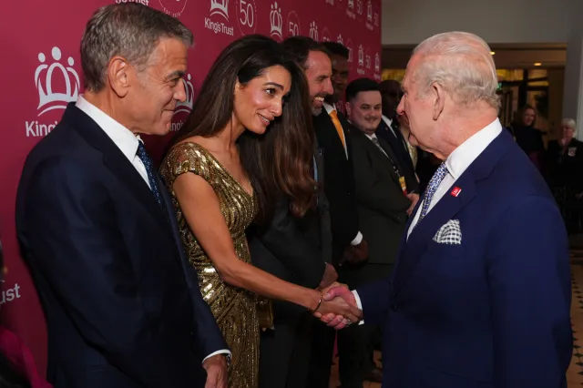 Amal Clooney shakes King Charles III's hand alongside husband George Clooney at 'A King's Trust 50th Anniversary Celebration' at the Royal Albert Hall, in London, England, on May 11, 2026.