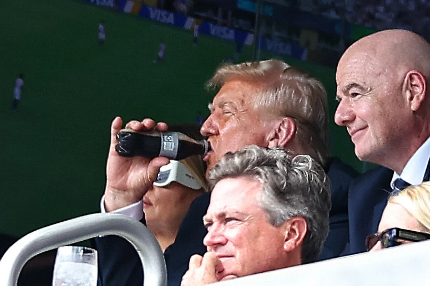 Trump drinks a bottle of Diet Coca-Cola as he watches a soccer match at MetLife Stadium, July 13, 2025, East Rutherford, New Jersey.
