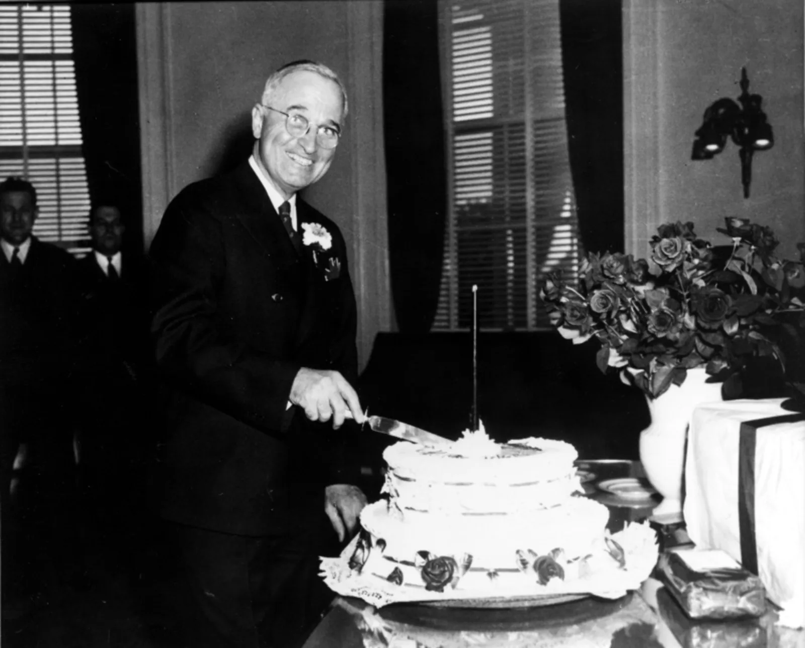 President Harry Truman smiles as he cuts his birthday cake during the celebration of his 61st birthday and his first full day as a resident of the White House on May 8, 1945. It coincided with Victory in Europe (V-E) Day, during which Truman broadcast the official news of Germany's unconditional surrender in World War II to the American public. (Harry S. Truman Library and Museum)