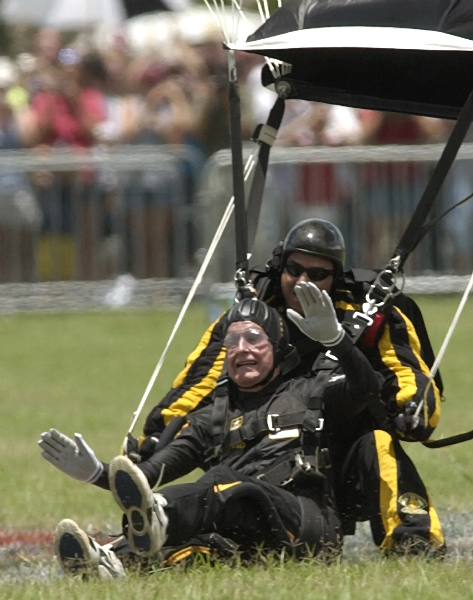 Former President George H.W. Bush parachutes to his landing after a tandem jump with Sergeant Bryan Schnell, a member of the U.S. Army Golden Knights, on June 13, 2004, at his presidential library in College Station, Texas, as part of his 80th birthday celebration. (AP Photo/David J. Phillip)