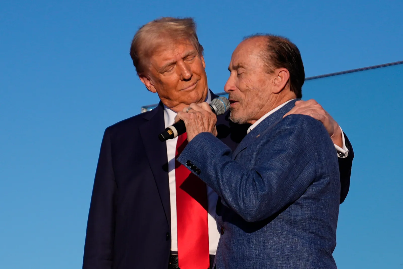 Republican presidential nominee former President Donald Trump greets Lee Greenwood as he arrives at a campaign rally at the Butler Farm Show, Saturday, Oct. 5, 2024, in Butler, Pa. (AP Photo/Evan Vucci)