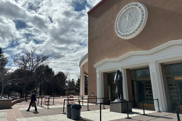 A man exits the state Capitol in Santa Fe, New Mexico, where state lawmakers on February 17, 2026, launched an investigation into past activity at a secluded desert ranch where financier and sex offender Jeffrey Epstein once entertained guests, and whether local authorities looked the other way. (AP Photo/Morgan Lee)