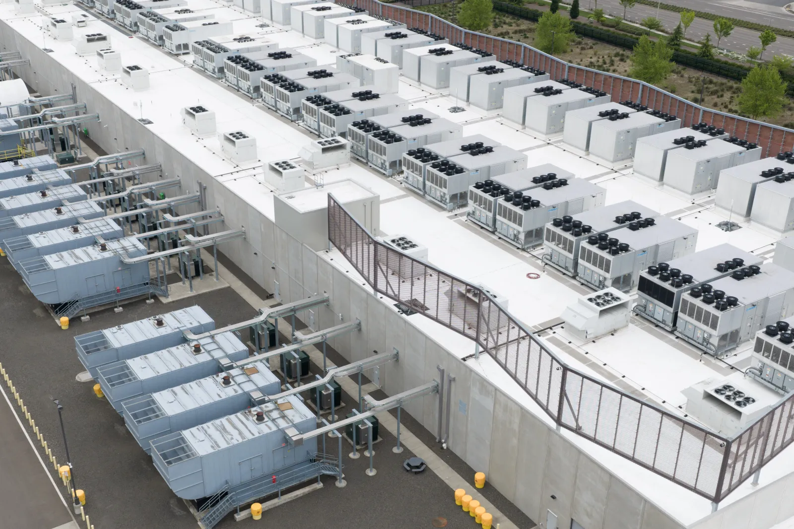 Fans that are part of a cooling system are shown on the roof of a data center on April 27, 2026, in Hillsboro, Oregon. (AP Photo/Jenny Kane)