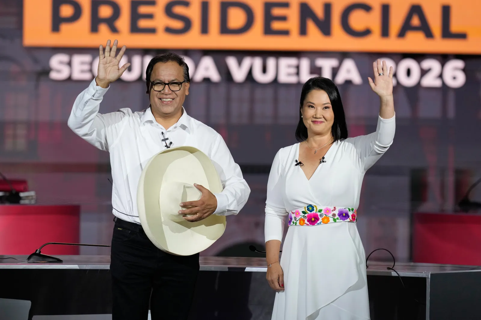 Presidential candidate Keiko Fujimori of the Popular Force party and her rival Roberto Sanchez of Together for Peru party wave during a presidential debate, in Lima, Peru, Sunday, May 31, 2026.