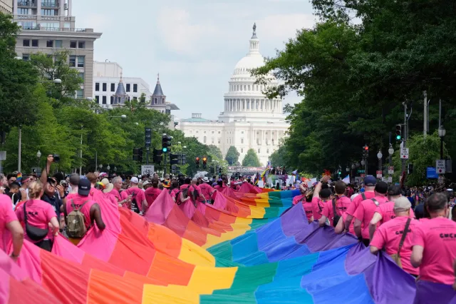 Participants carry a large LGBTQ+ pride flag during the World Pride parade in Washington, D.C., on June 7, 2025.