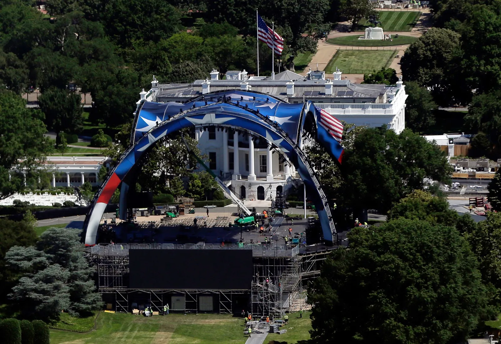 Workers continue building the cage for a future UFC fight on the South Lawn in front of the White House, Wednesday, June 3 2026, in Washington, as work continues on the construction of the ballroom, right, as seen from the Washington Monument. (AP Photo/Rahmat Gul)