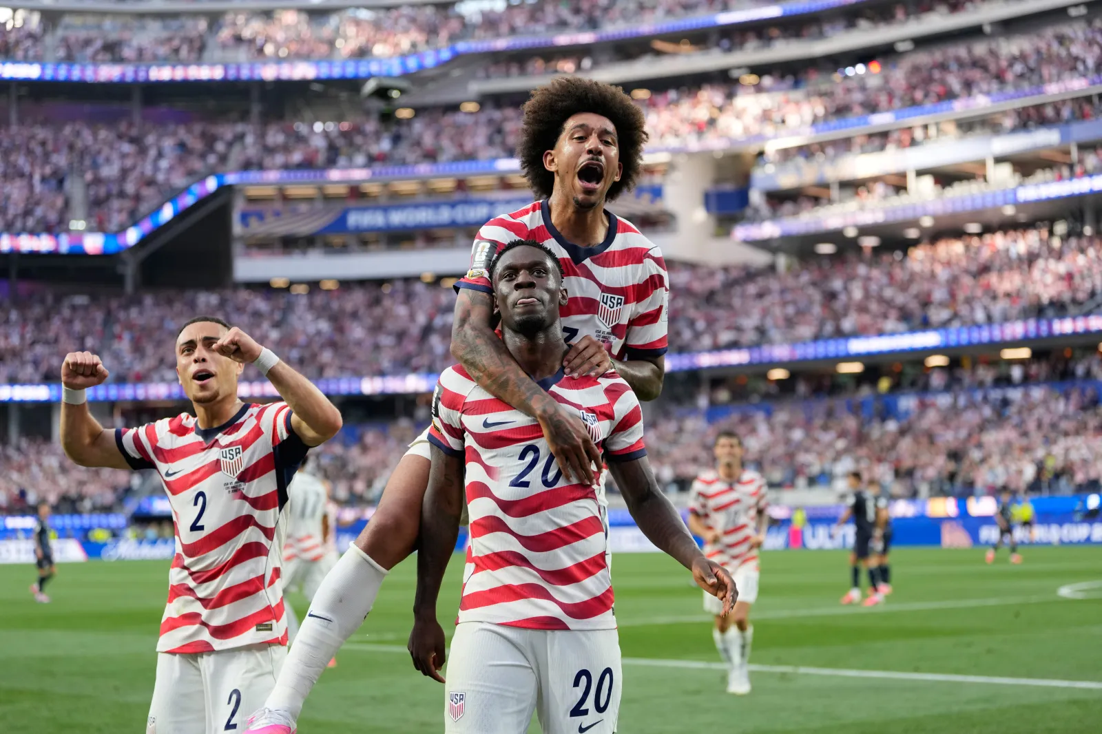 United States' Folarin Balogun (20) celebrates scoring his side's third goal against Paraguay with teammates during the World Cup Group D soccer match in Inglewood, California, on June 12. (AP Photo/Andre Penner)