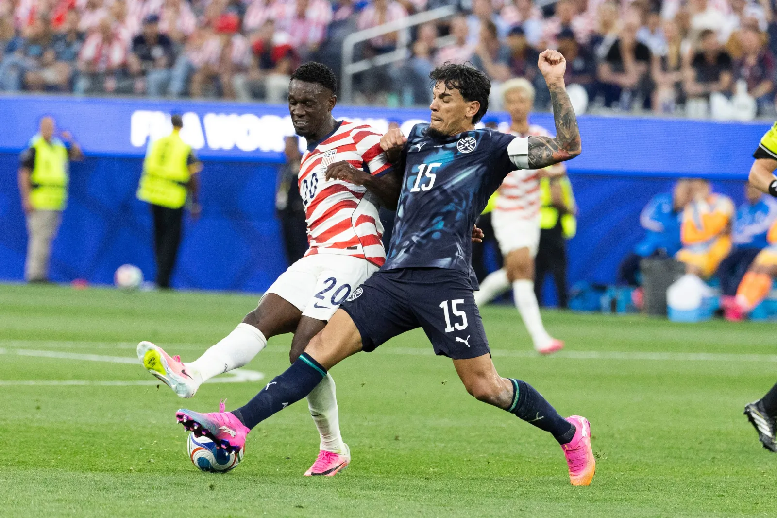 United States' Folarin Balogun (20) and Paraguay' Gustavo Gomez (15) vie for the ball during the FIFA World Cup Group D soccer match in Inglewood, California, on June 12. (Ringo Chiu via AP)