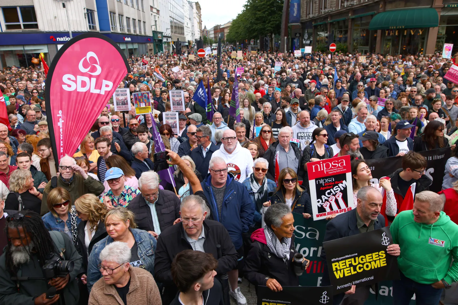 People gather during an anti-racism rally outside Belfast City Hall sparked by a knife attack on a man in north Belfast on Monday in Belfast on June 13. (Peter Morrison/PA via AP)