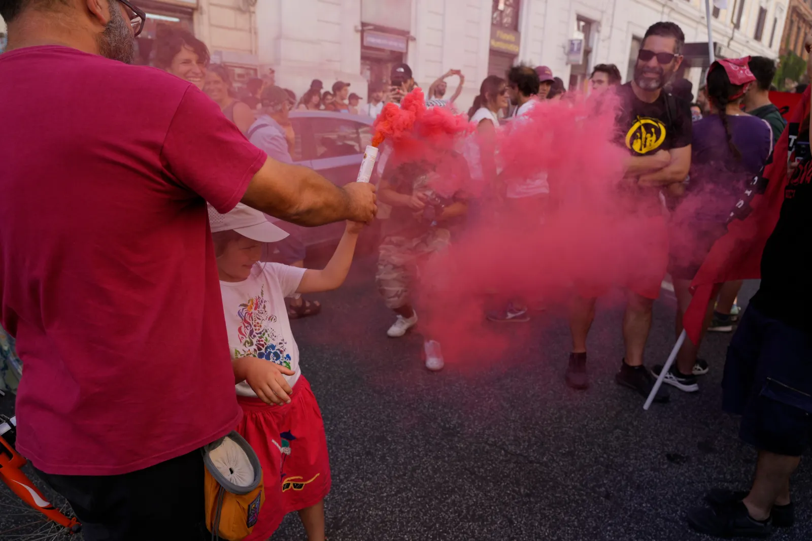 Demonstrators light flares during a march in Rome on June 13 to protest Italy's security and migration package, including a migrant