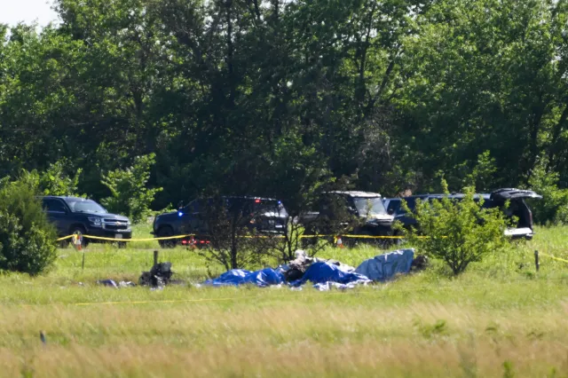 Part of the wreckage of a plane crash is covered with a blue tarp at Butler Memorial Airport in Missouri on June 14.