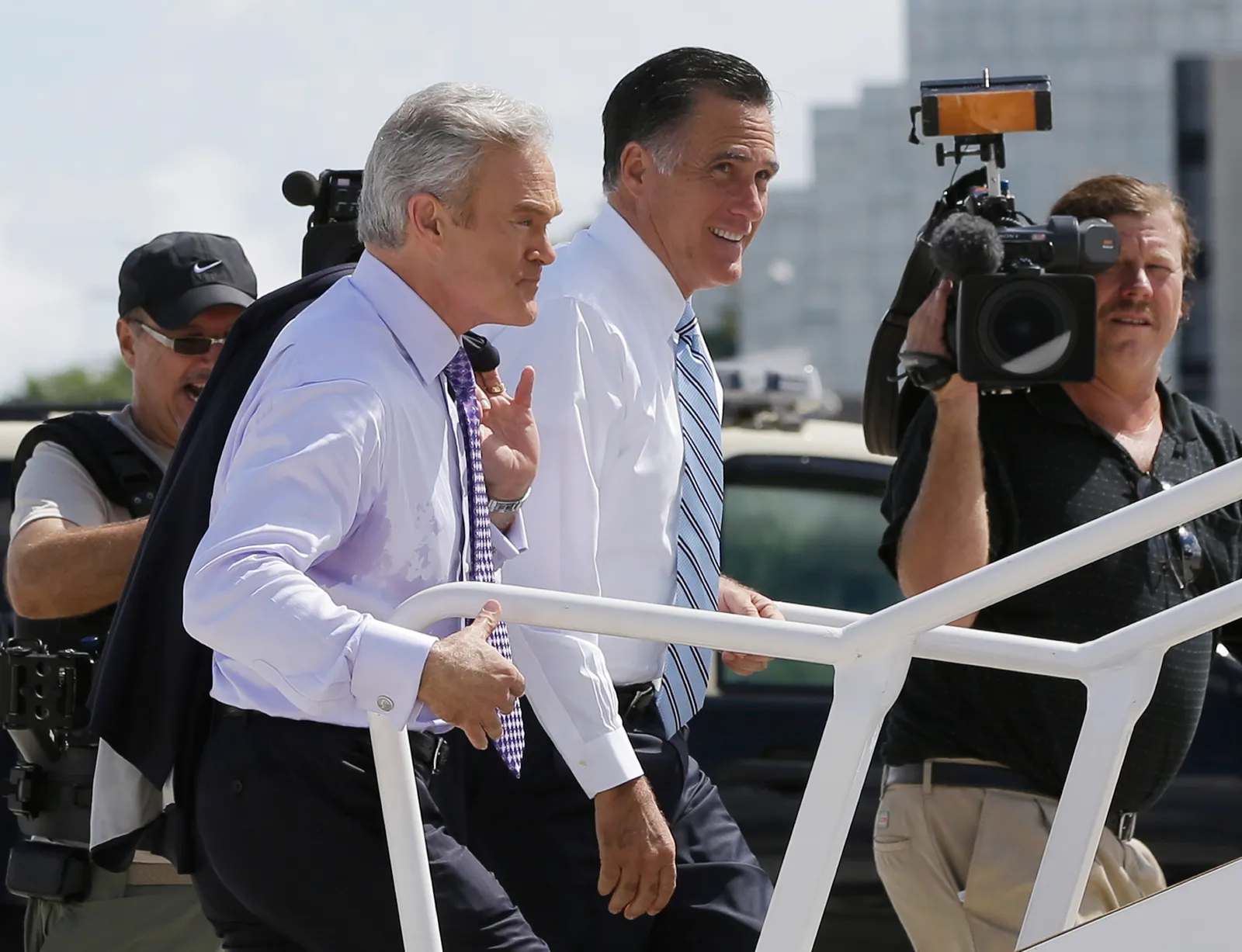 Republican presidential candidate and former Massachusetts Gov. Mitt Romney boards his campaign plane with Scott Pelley, left,  of CBS News in Miami, Thursday, Sept. 20, 2012.  (AP Photo/Charles Dharapak)