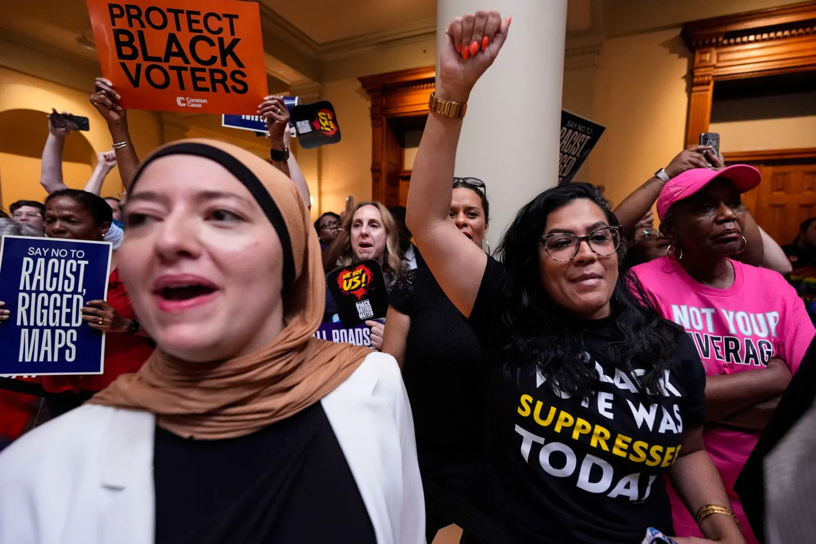 People listen and cheer as lawmakers speak about redistricting during a special legislative session at the state capitol, Wednesday, June 17, 2026, in Atlanta.