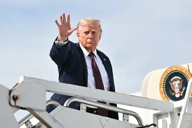 Donald Trump waves as he boards Air Force One before departing from Reading Regional Airport (RDG) in Berks County, Pennsylvania on June 23, 2026.