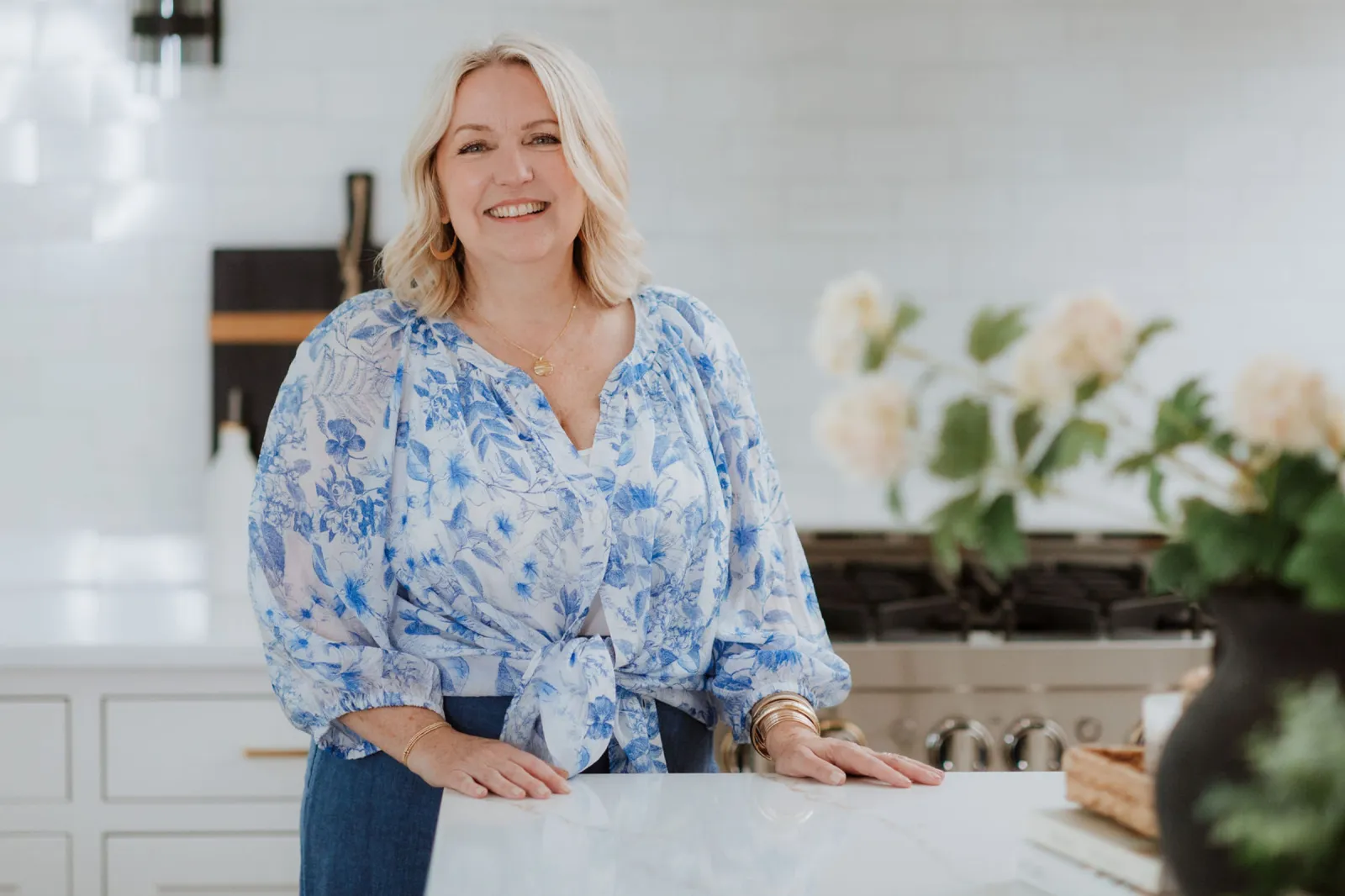 Juli Ford stands and smiles in her kitchen.