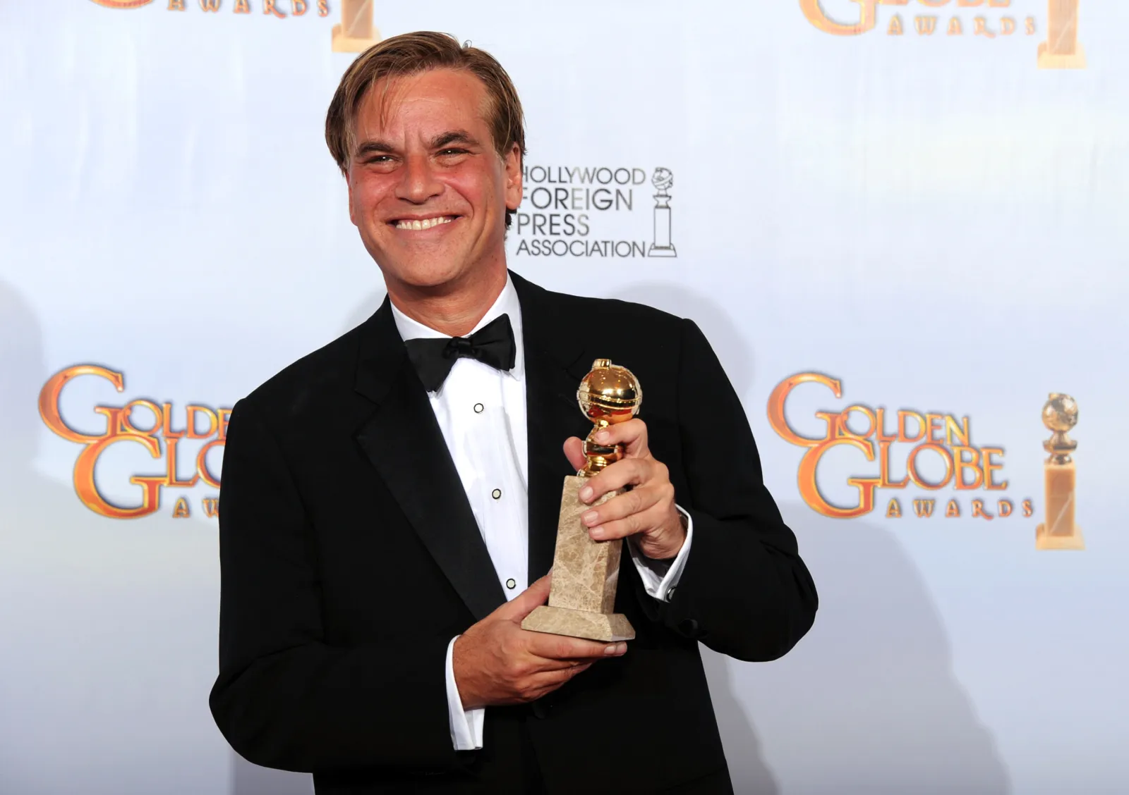Aaron Sorkin poses with his award for Best Screenplay for "The Social Network" at the Golden Globes on January 16, 2011.