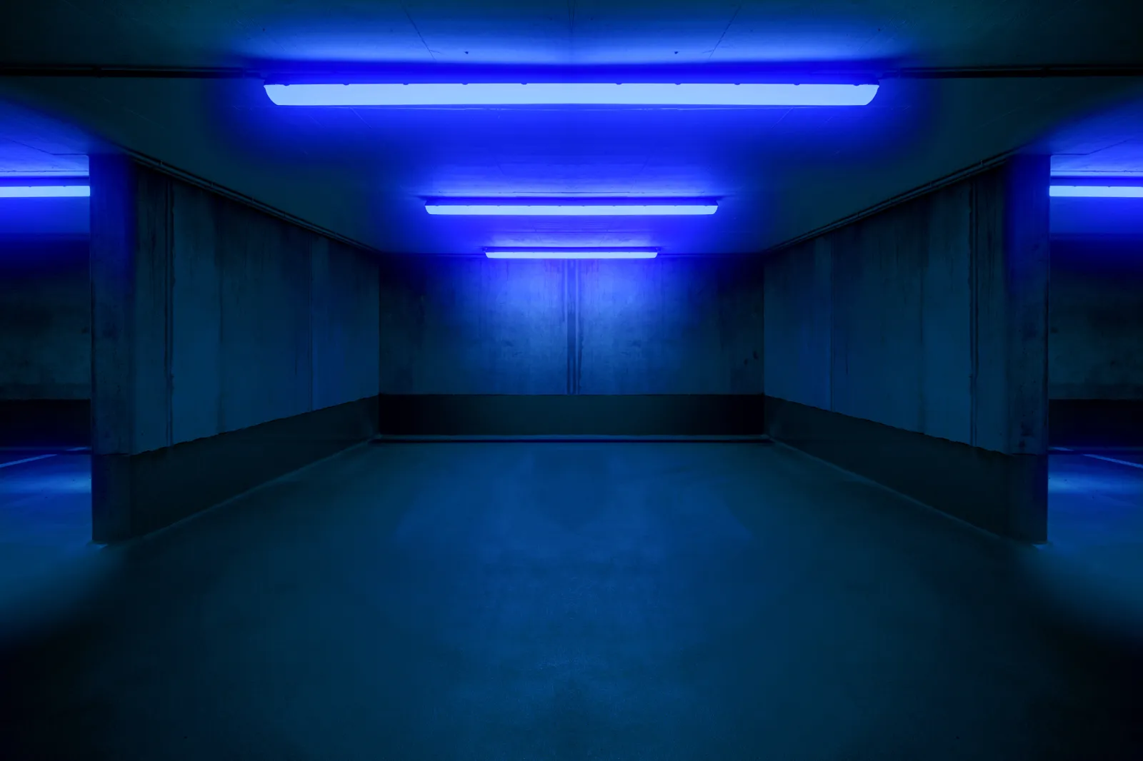 An empty parking lot with fluorescent lighting.