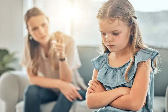 A stock image of a child being reprimanded by an adult.