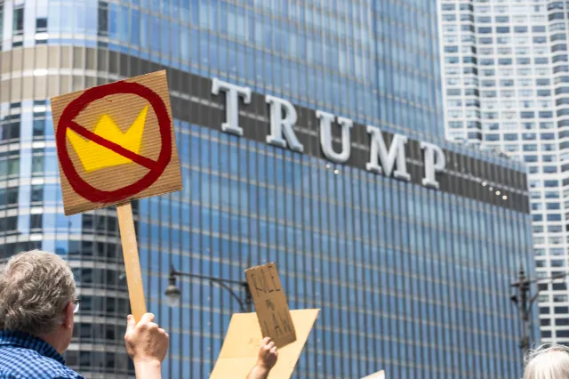 Protesters march past Trump International Hotel in downtown Chicago during a No Kings demonstration on June 14, 2025.