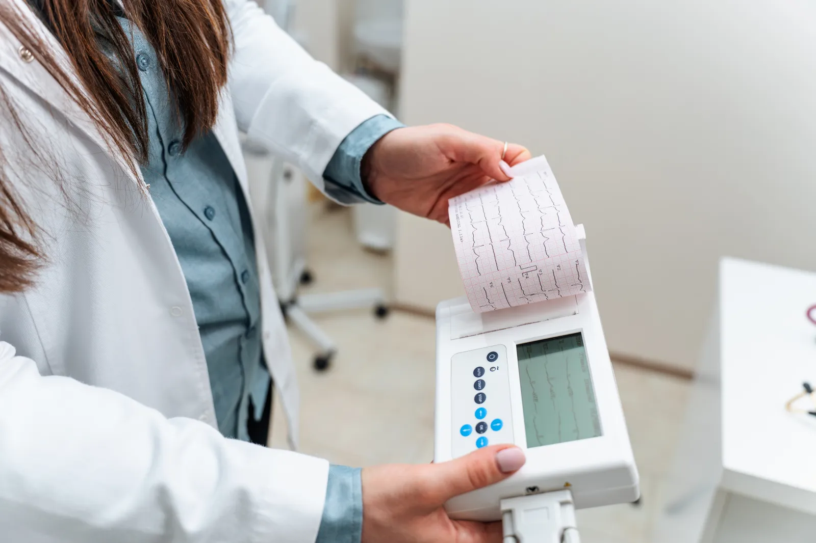 Stock image of medical staff performing an EKG in a hospital setting.