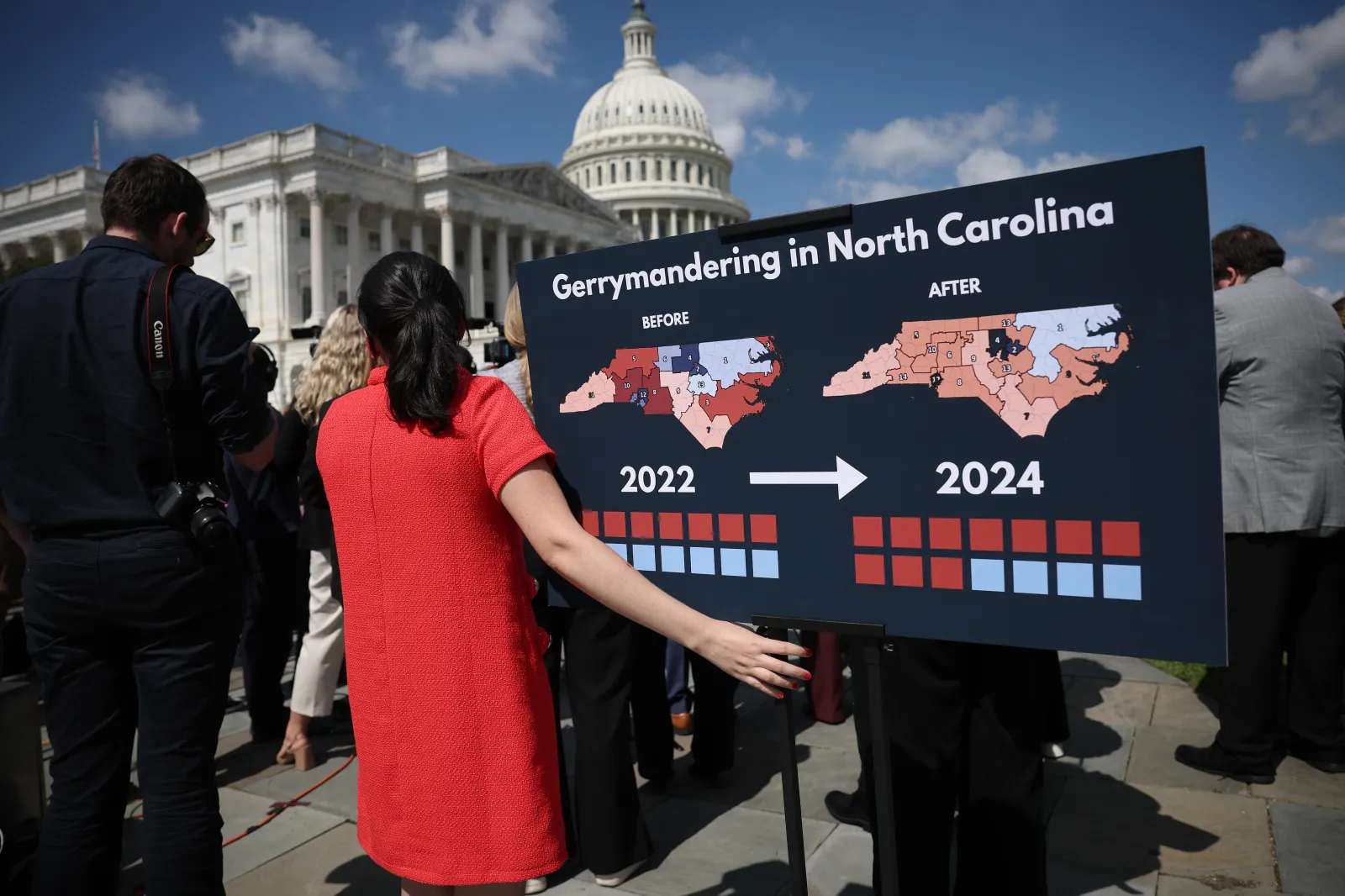 A staff member holds a chart showing the redistricting that has taken place in the state of North Carolina as members of Congress speak during a news conference outside the U.S. Capitol on September 18, 2025, in Washington, D.C. (Photo by Win McNamee/Getty Images)